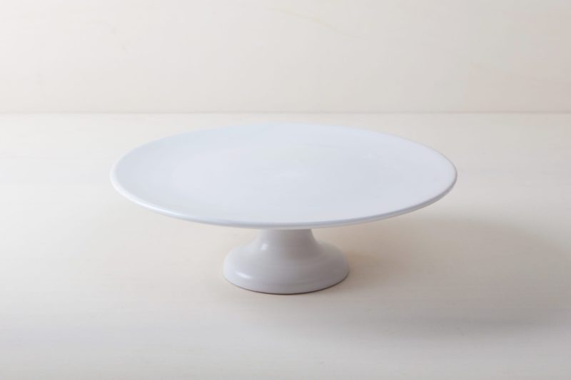  | Our large round elevated cake stand Ernesta rests on a 15 cm high foot and has a diameter of 40 cm. Enough space to present and serve cakes, cupcakes, sushi and other delicious food on the table or at the modern buffet. The serving trays are handcrafted from high-quality terracotta and glazed matt white, of course food safe.
These cake stands are available in three different sizes as well as a matt black serving plate. They can be wonderfully combined for presentations. | 