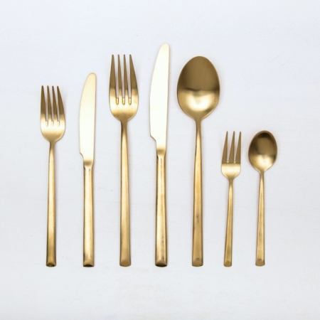 Cutlery Set Ines Gold Matte 7-pieces | With the cutlery series Ines we rent out wonderful, matt-gold stainless steel cutlery. The cutlery has a wonderful haptic and looks equally good for different types of events. Whether on a colourful table setting combined with strong colours, an elegant, minimalistic wedding or a stylish business dinner - our matt gold cutlery Ines is an excellent choice for your event.The assembled set of rental cutlery contains a starter and dinner fork, starter and dinner knife, a table spoon, a cake fork and a teaspoon.Impress your guests, rent the 7 piece golden cutlery sets Ines and combine it with our vintage tableware.Matching the matt gold cutlery set Ines, we also offer cake shovels, serving spoons, butter shovels and vintage stemware for rent. | gotvintage Rental & Event Design