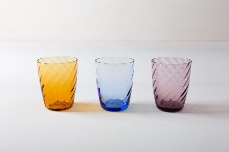  | These gracile water glasses made of colored glass are available in purple, blue and amber. This way, the colors can be perfectly combined with your table and flower decorations. We also offer mismatching wine glasses from our series Patricia or the Acadia Smoke wine glasses with gold rim.
The glasses are handmade and can differ in their colour intensity. | 
