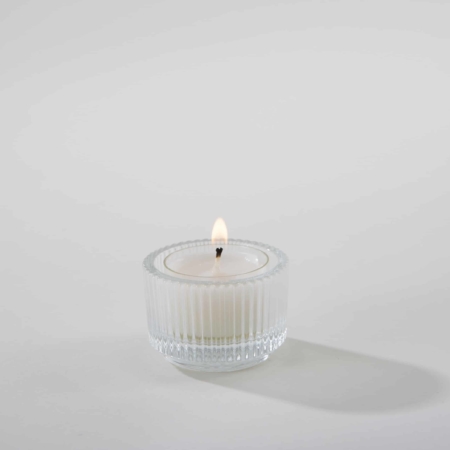 Tealight holder Tilian made of fluted, clear glass | For a festive table decoration adorned over and over with small twinkling look no further: our "Tilian" tea light holders made of fluted clear glass add particularly beautiful sparkling effects. They are just as beautiful draped in small groups as they are individually scattered all over the table. With their minimalist design, they adapt to almost any table decoration, from romantic to modern, from rustic to opulent. | gotvintage Rental & Event Design